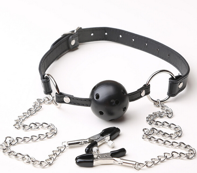 A classic black solid ball gag with an adjustable faux-leather strap and two integrated metal alligator nipple clamps on silver chains.