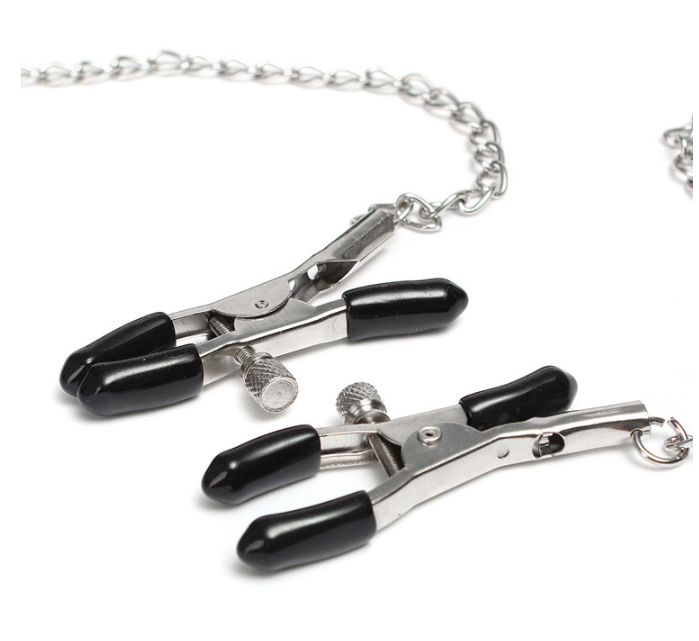 A classic black solid ball gag with an adjustable faux-leather strap and two integrated metal alligator nipple clamps on silver chains.