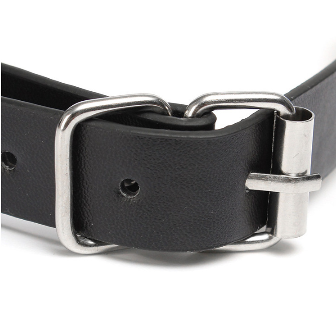 A classic black solid ball gag with an adjustable faux-leather strap and two integrated metal alligator nipple clamps on silver chains.