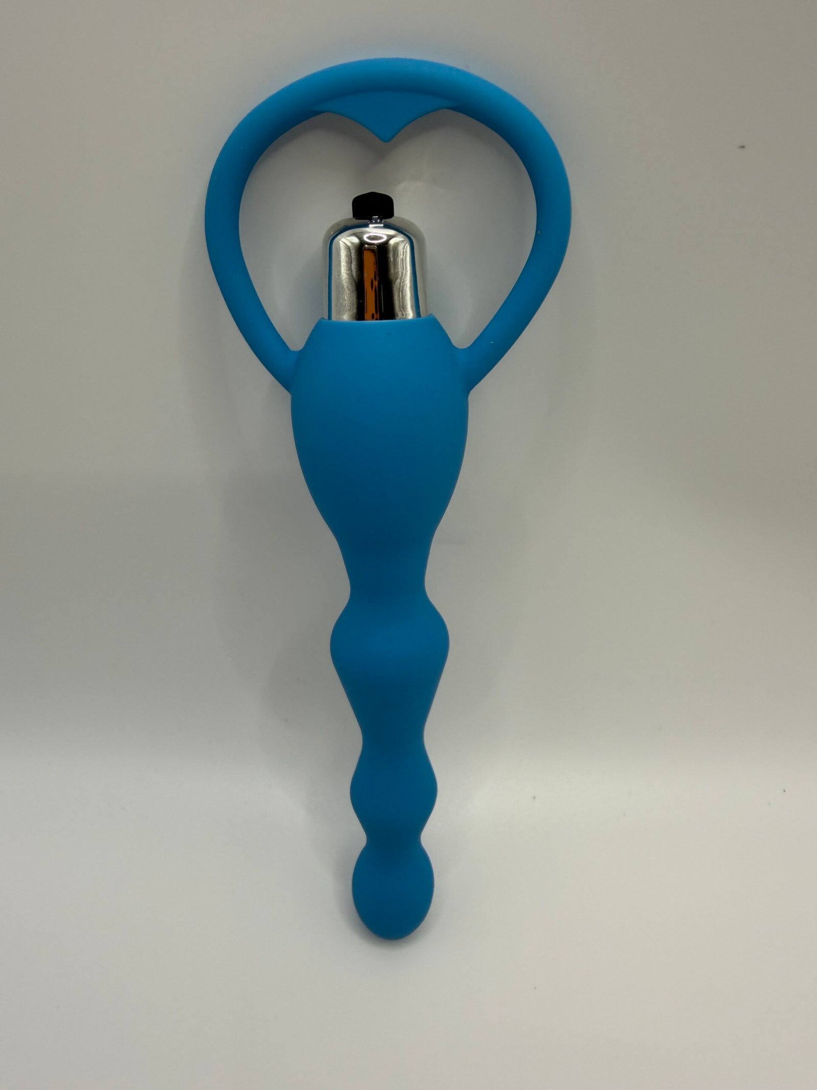 Ergonomically curved vibrating prostate plug with a flared safety base in pink and blue