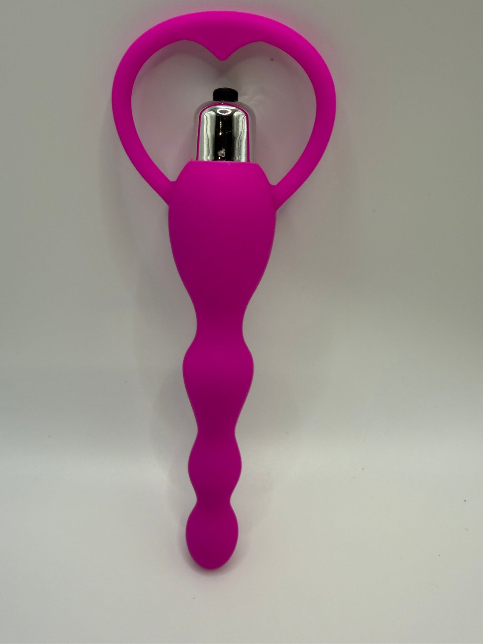 Ergonomically curved vibrating prostate plug with a flared safety base in pink and blue