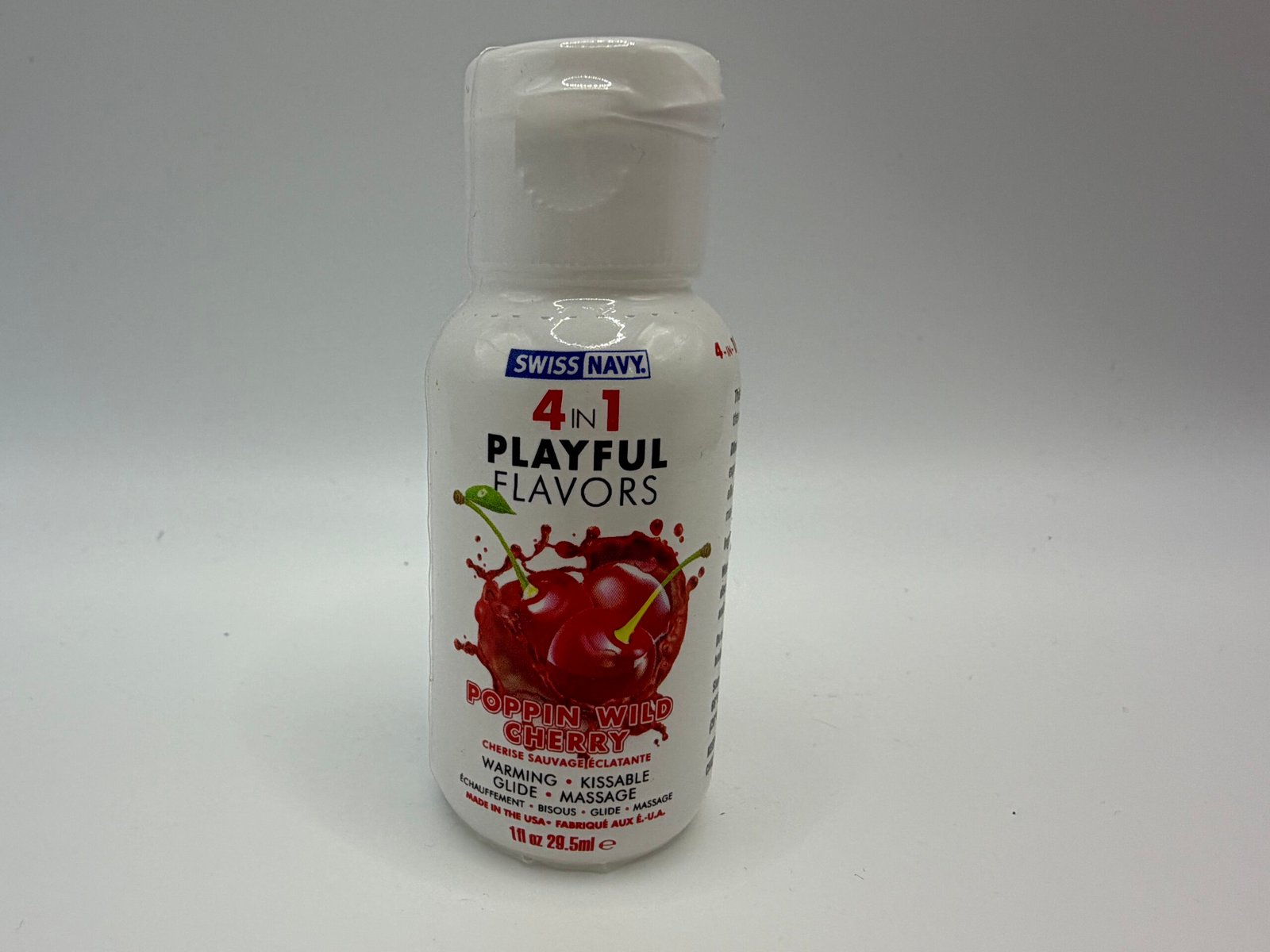 Swiss Navy 4-in-1 Playful Flavors Poppin' Wild Cherry water-based glide, 1 fl oz bottle showing warming and kissable feature